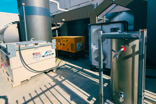 Temporary cooling setup featuring a 21kW air-cooled chiller, portable fan coil unit, and a 28kVA generator, ensuring efficient cooling for a dairy production facility in Melbourne.