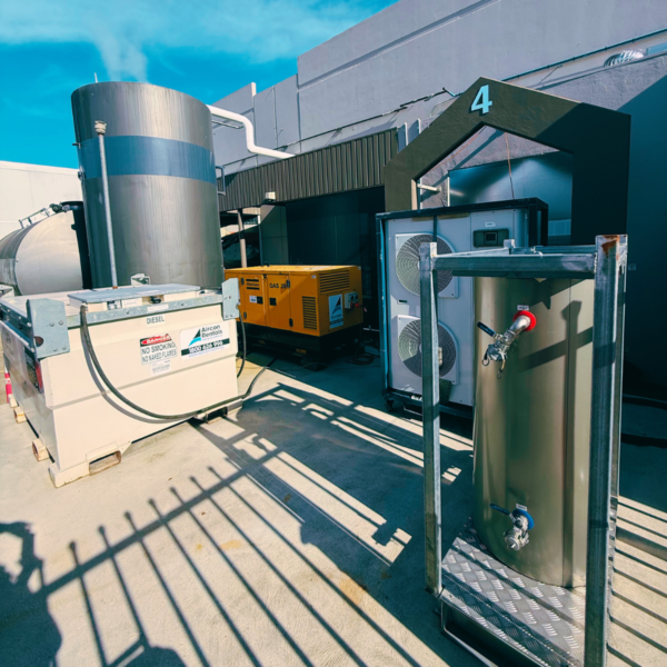 Temporary cooling setup featuring a 21kW air-cooled chiller, portable fan coil unit, and a 28kVA generator, ensuring efficient cooling for a dairy production facility in Melbourne.